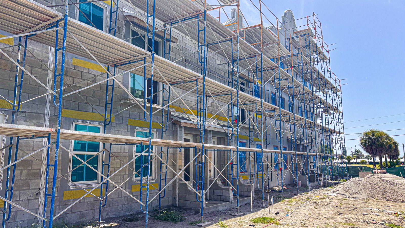 Multi-story building under construction with scaffolding